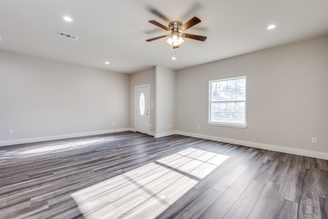 empty room with recessed lighting, visible vents, dark wood finished floors, and baseboards