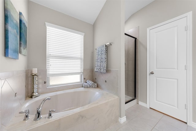 bathroom with a garden tub, tile patterned flooring, and a shower stall