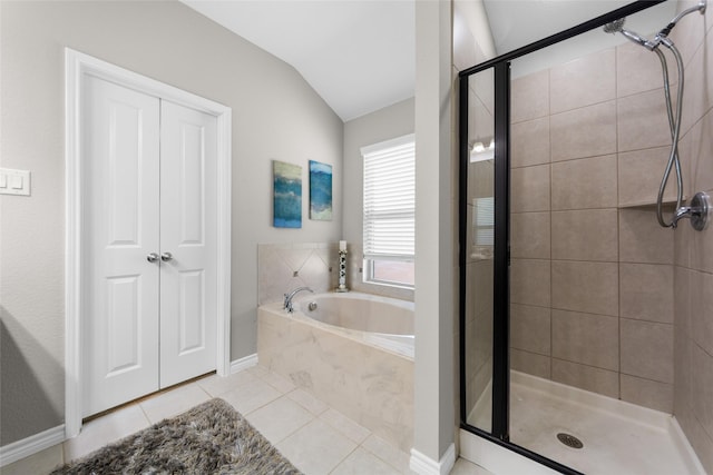 full bath featuring tile patterned flooring, a garden tub, baseboards, vaulted ceiling, and a stall shower