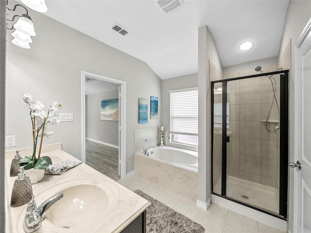 bathroom with a bath, tile patterned flooring, vanity, and visible vents