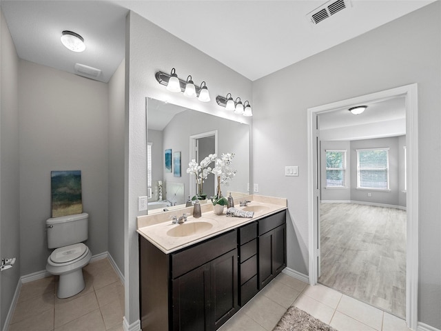 bathroom with tile patterned flooring, visible vents, and a sink