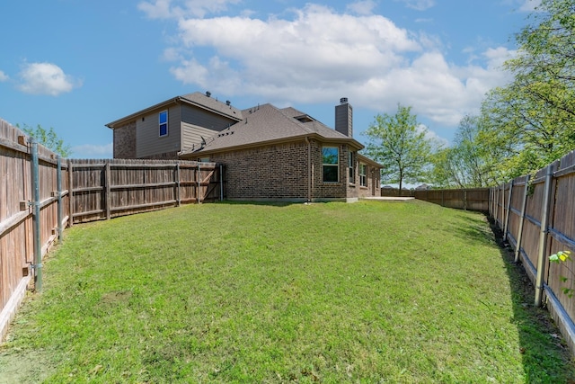 view of yard with a fenced backyard