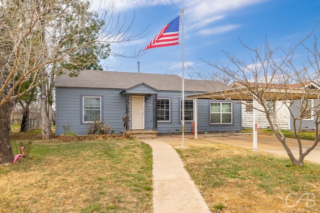 single story home with a front yard, crawl space, and roof with shingles