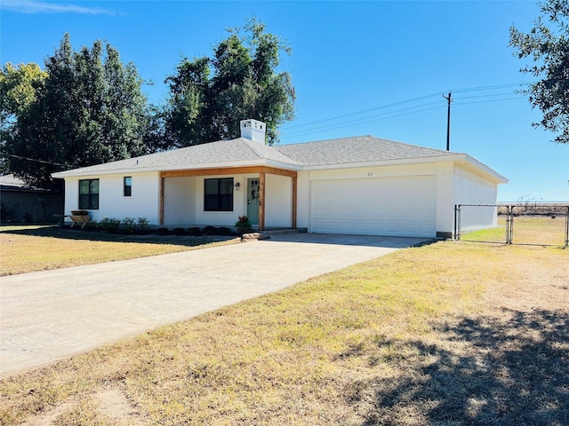 single story home featuring driveway, an attached garage, a gate, fence, and a front yard