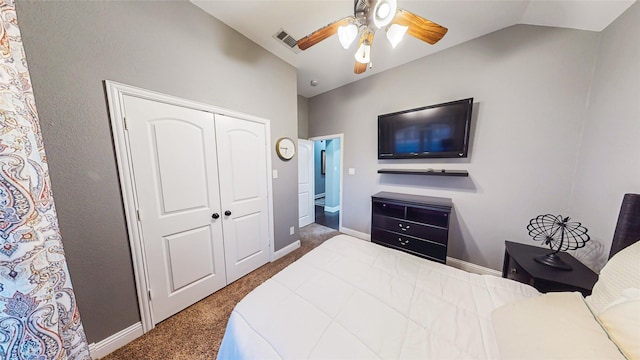 bedroom with a ceiling fan, baseboards, vaulted ceiling, a closet, and dark carpet