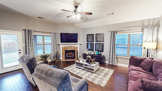 living area with a wealth of natural light, a fireplace, and visible vents