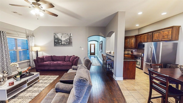 living room featuring arched walkways, ceiling fan, recessed lighting, visible vents, and light wood finished floors