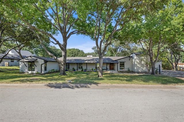 view of front of property with a garage, a front lawn, and a gazebo