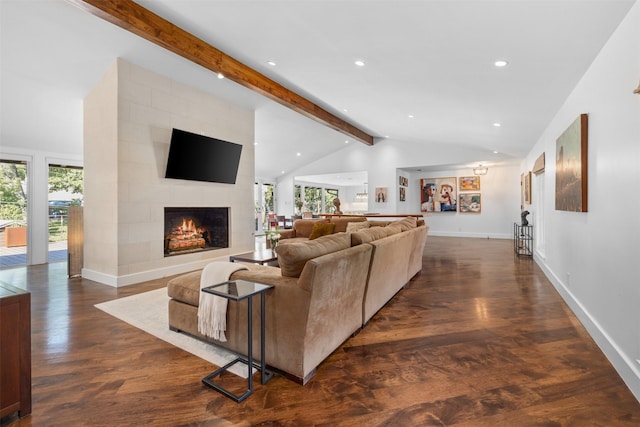 living room with vaulted ceiling with beams, a wealth of natural light, dark wood-type flooring, and a fireplace