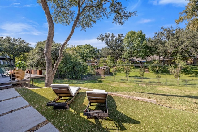 view of property's community with a lawn and fence