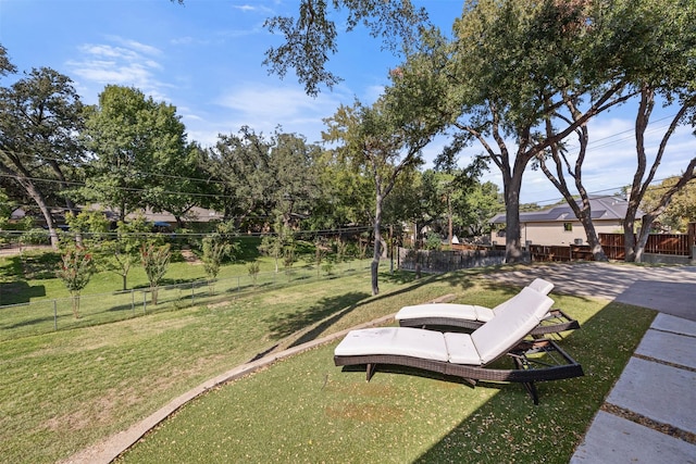 view of property's community featuring a fenced backyard and a yard