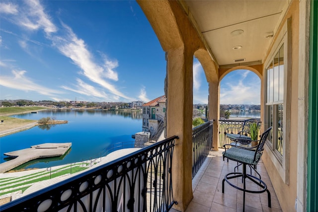 balcony featuring a water view and visible vents