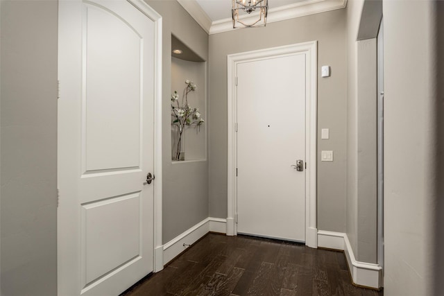 entryway with ornamental molding, dark wood-style flooring, and baseboards