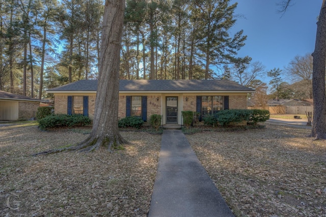 view of front facade featuring fence and brick siding