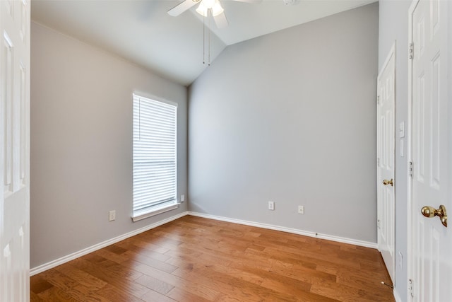 unfurnished bedroom with lofted ceiling, light wood finished floors, baseboards, and a ceiling fan