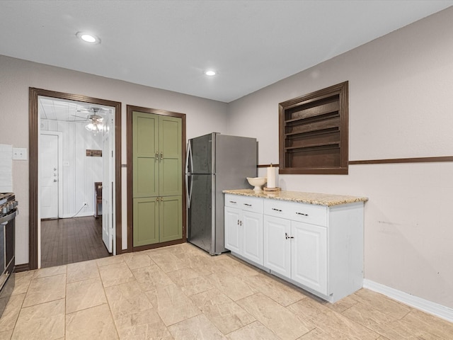 kitchen featuring open shelves, recessed lighting, freestanding refrigerator, white cabinets, and range