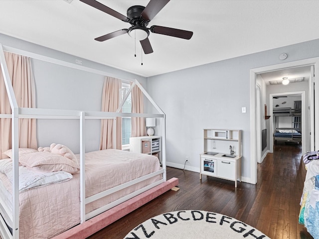 bedroom featuring ceiling fan, dark wood finished floors, and baseboards