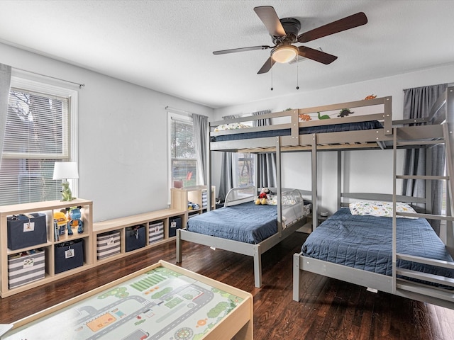 bedroom with a ceiling fan, a textured ceiling, and wood finished floors