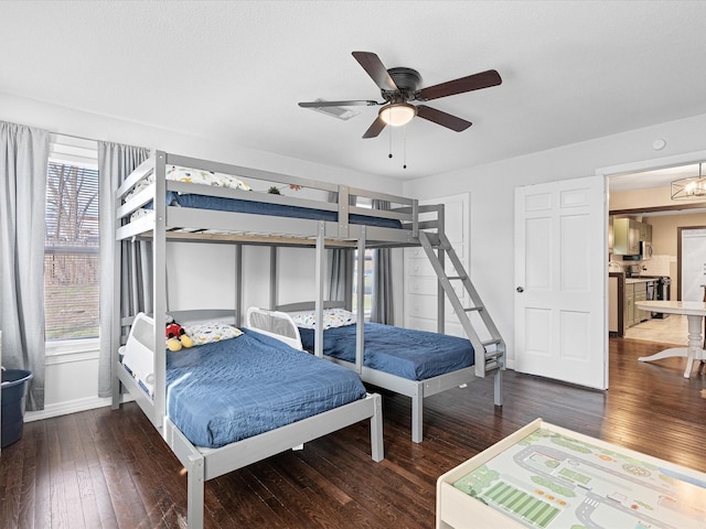 bedroom featuring ceiling fan, baseboards, and dark wood-type flooring