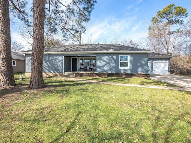 ranch-style house featuring an attached garage, driveway, and a front yard