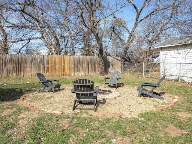 view of yard with an outdoor fire pit and a fenced backyard