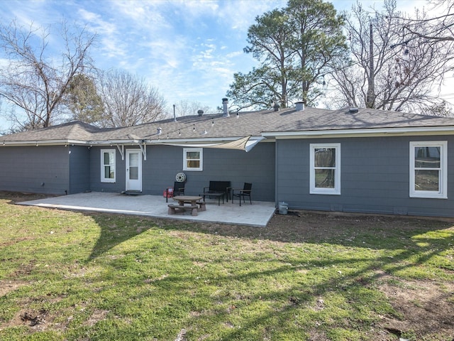 rear view of property featuring a patio and a lawn