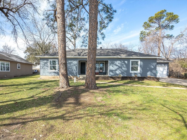 ranch-style house with a garage and a front lawn