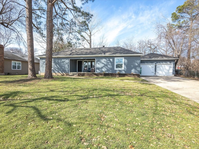 view of front facade featuring an attached garage, driveway, and a front lawn