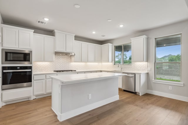 kitchen with white cabinets, visible vents, appliances with stainless steel finishes, and light countertops