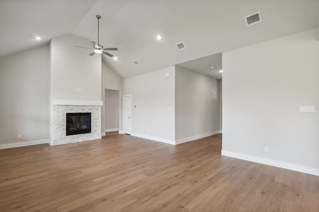 unfurnished living room with a fireplace, visible vents, and light wood-style floors