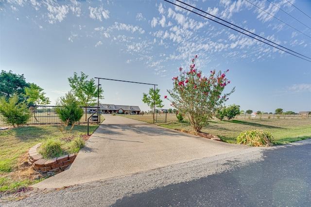 view of front of home featuring a rural view, a front yard, and fence