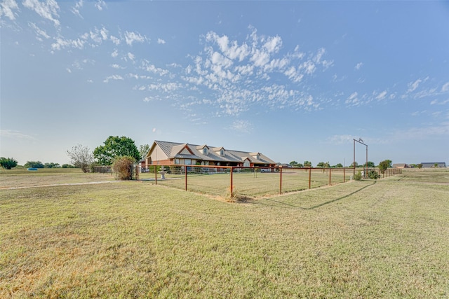 view of yard with a rural view and fence