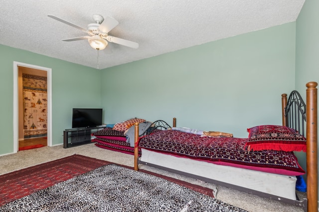 bedroom with a textured ceiling, connected bathroom, carpet floors, a ceiling fan, and baseboards