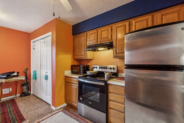 kitchen with stainless steel appliances, brown cabinets, light countertops, and under cabinet range hood