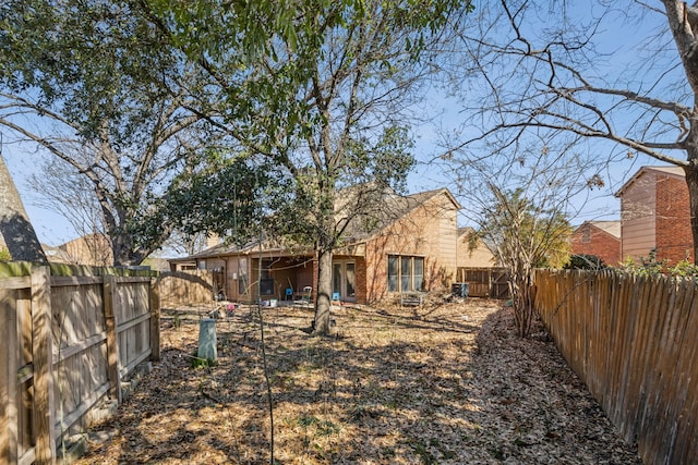 back of property with a fenced backyard