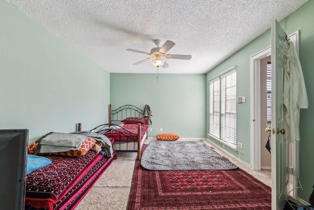 bedroom featuring carpet, ceiling fan, a textured ceiling, and baseboards