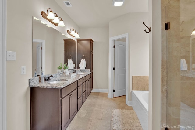 bathroom featuring a bath, double vanity, a sink, and visible vents