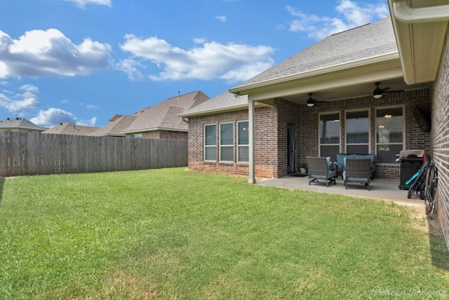 view of yard with a fenced backyard, ceiling fan, and a patio