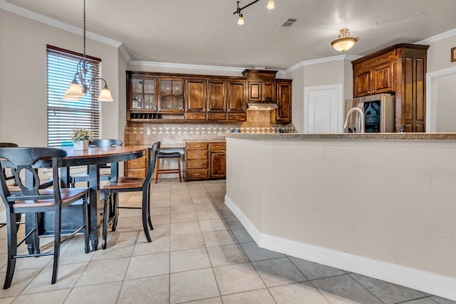 kitchen with light tile patterned floors, ornamental molding, under cabinet range hood, smart refrigerator, and backsplash