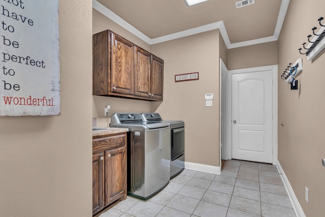 laundry area with visible vents, baseboards, washer and dryer, cabinet space, and crown molding