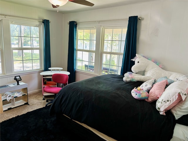 bedroom with carpet, multiple windows, and baseboards