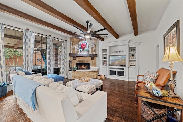 living room featuring plenty of natural light, beam ceiling, dark wood-style flooring, and a stone fireplace