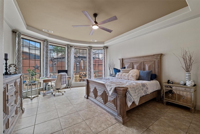 bedroom featuring a tray ceiling, visible vents, and light tile patterned flooring