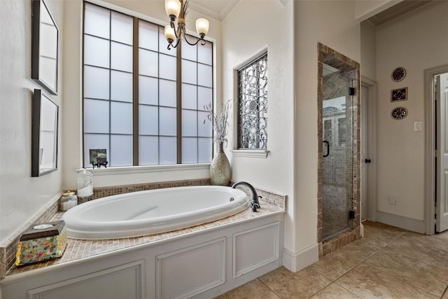 bathroom featuring a chandelier, tile patterned flooring, a garden tub, a stall shower, and crown molding