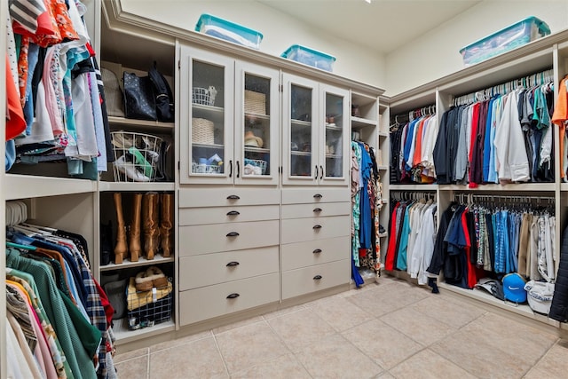 walk in closet with light tile patterned flooring