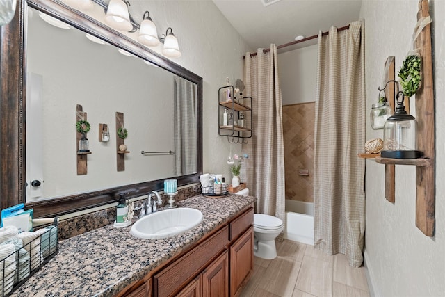 full bath with a textured wall, vanity, toilet, and shower / tub combo with curtain