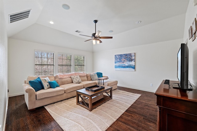 living room featuring visible vents, dark wood finished floors, and a tray ceiling