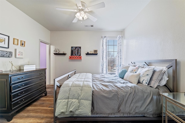 bedroom featuring ceiling fan, dark wood-style flooring, and visible vents