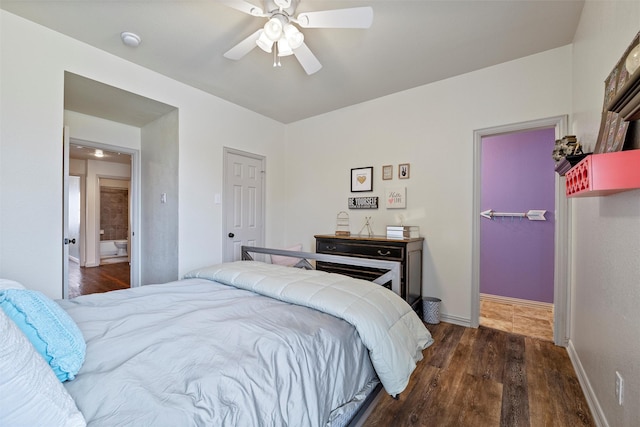 bedroom featuring ceiling fan, a closet, baseboards, and dark wood-type flooring