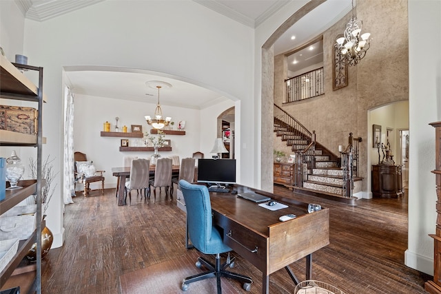 office space featuring arched walkways, a towering ceiling, an inviting chandelier, dark wood-type flooring, and ornamental molding